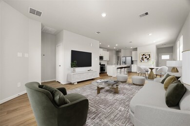 This open-concept living space offers seamless flow between the family room, dining area, and modern kitchen. Featuring neutral tones, recessed lighting, and luxury vinyl plank flooring, the room feels bright and inviting. Large windows fill the space with natural light, creating a warm and welcoming atmosphere perfect for everyday living or entertaining.