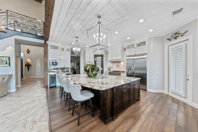 Kitchen with glass insert cabinets, decorative backsplash, a breakfast bar, recessed lighting, and wood ceiling