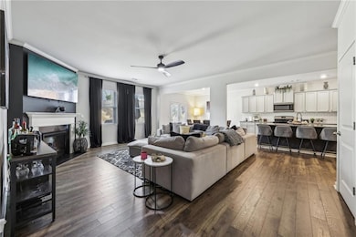 Living room with ceiling fan, ornamental molding, 