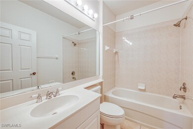 Full bathroom featuring tile patterned flooring, v