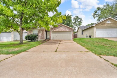 View of front of home featuring a garage, brick s