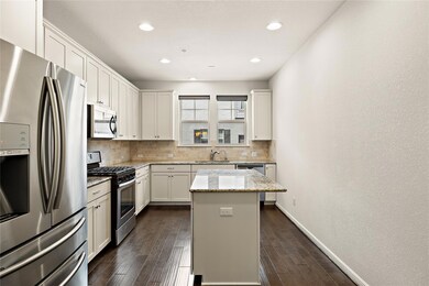 Kitchen featuring dark wood-style flooring, stain