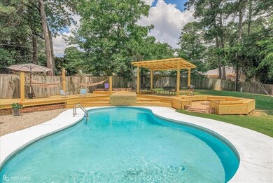 View of swimming pool with a fenced backyard, a fe
