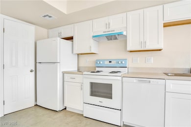 Kitchen with light countertops, under cabinet rang