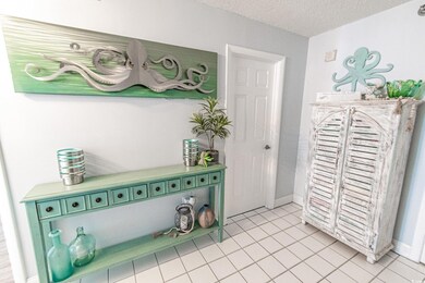Interior space with green cabinets, light tile pat