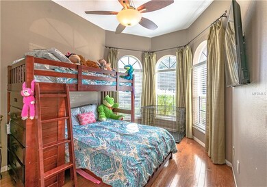 Bedroom 3 has wood floors & a bay window.