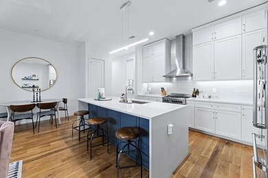 Kitchen with a kitchen island with sink, a breakfa