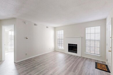 Unfurnished living room featuring a textured ceili
