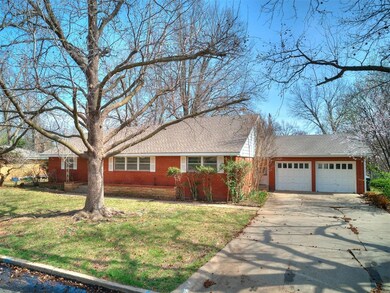 Single story home featuring a front lawn and a gar