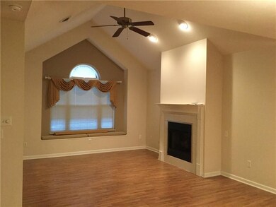 Living Room:  Vaulted ceiling with a ceiling fan &