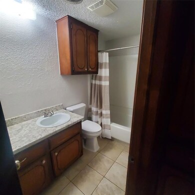 Full bathroom featuring shower / bath combo, tile 