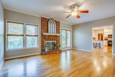 LIVING ROOM FEATURES:Gas fireplace brick surround, White mantel with Brick corbels, Blinds, Ceiling fan, Crown molding, New paint, French doors that lead to deck