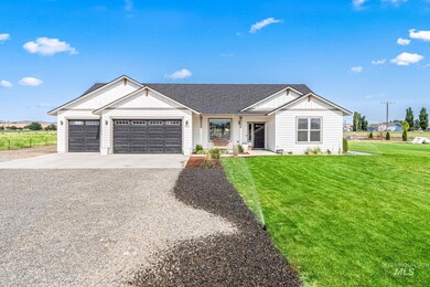 Modern farmhouse style home featuring driveway, a garage, a front yard, board and batten siding, and a shingled roof