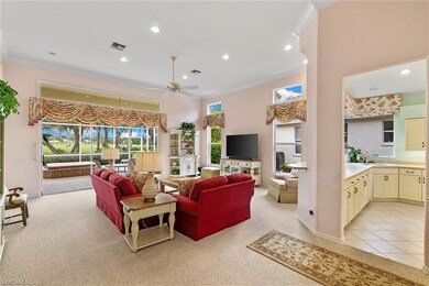 Living room featuring crown molding, light colored carpet, recessed lighting, ceiling fan, and light tile patterned floors