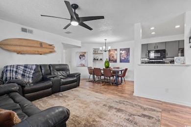 Living room featuring a chandelier, wood finished 