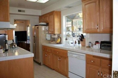 Kitchen opens to dining areas on two sides with di