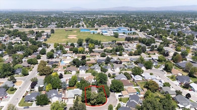 Aerial view of property and surrounding area with property parcel outlined and a mountain backdrop
