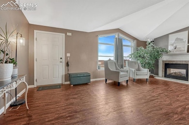 Family room with lofted ceiling, LVP floors, and a