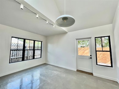 Unfurnished room with concrete flooring and rail 