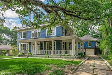 View of front of house with a garage, a porch, and