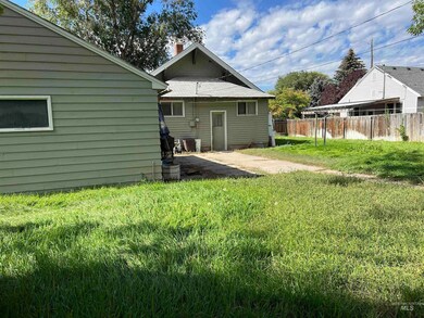 Back of house featuring a chimney and a patio
