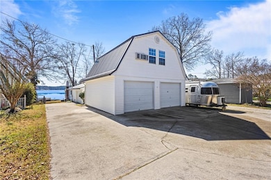 Garage with a water view and driveway