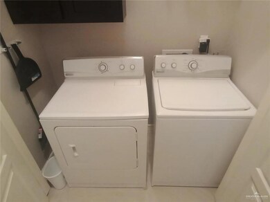 Laundry room featuring washing machine and clothes dryer and cabinet space