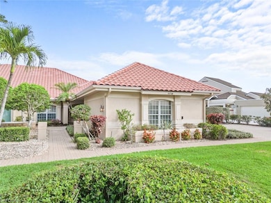 Mediterranean / spanish home featuring stucco siding, a tile roof, and a front lawn