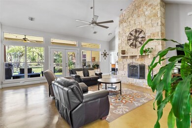 Living room featuring visible vents, ceiling fan,
