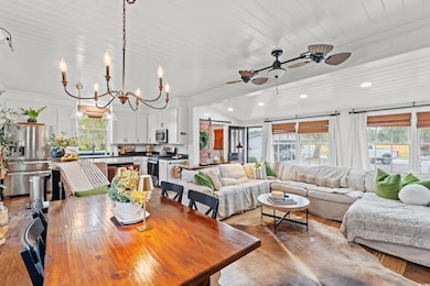 Dining space with ceiling fan, ornamental molding, light wood finished floors, a chandelier, and recessed lighting