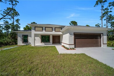 Prairie-style house with stucco siding, a garage,