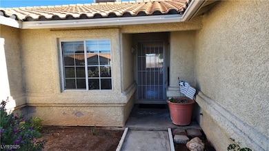 View of exterior entry featuring stucco siding and