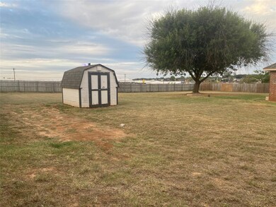 View of yard featuring a storage unit