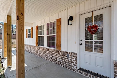 Property entrance featuring brick siding