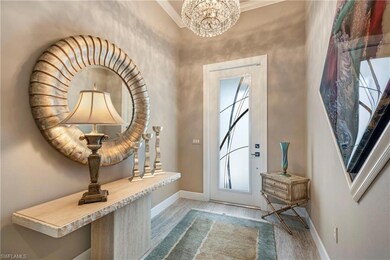 Doorway to outside with a chandelier, light wood-s