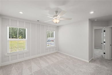 Empty room with light colored carpet, recessed lighting, and a ceiling fan