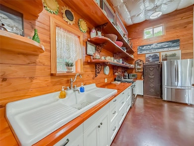 Kitchen with stainless steel appliances, wood wal