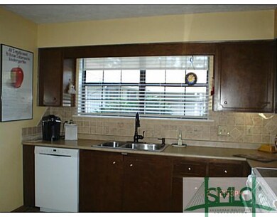 Kitchen. Bright & sunny with solar shade that prov