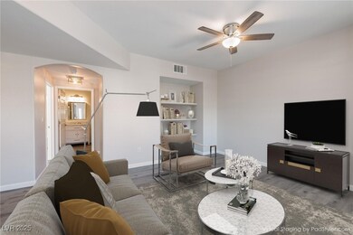 Living area featuring arched walkways, visible ven