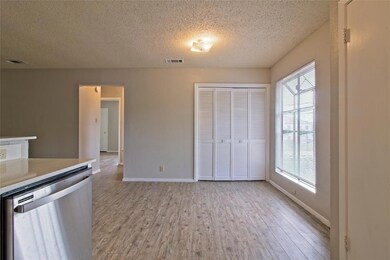 Kitchen with baseboards, light wood-type flooring