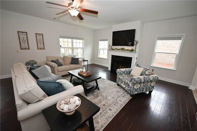 Living room boasts cozy wood-burning fireplace wit