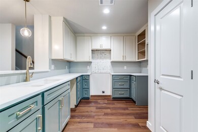 Kitchen featuring decorative light fixtures, dark 