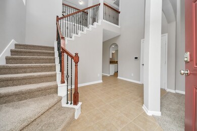 Entry to the home with an inviting staircase.
