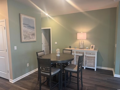 Dining area featuring dark hardwood / wood-style f