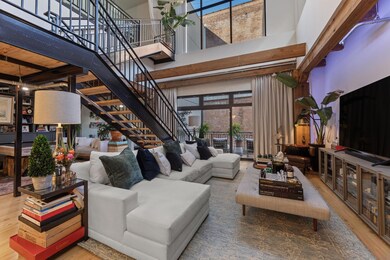 Living room with a wealth of natural light, stairw