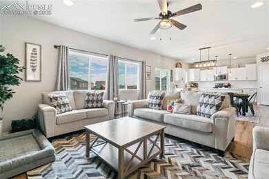 Living area with light wood-style floors, recessed lighting, and a ceiling fan