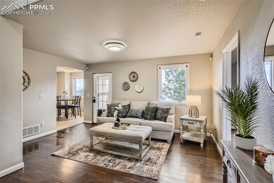 Step inside and be greeted by a spacious and inviting living area, adorned with large windows that flood the space with natural light.