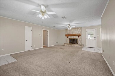 Unfurnished living room with ceiling fan, carpet f