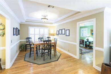 Large dining room with hardwood floors and tray ce