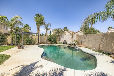 View of swimming pool with a pergola, a fenced bac